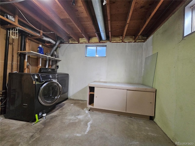 basement with washer and clothes dryer and a healthy amount of sunlight