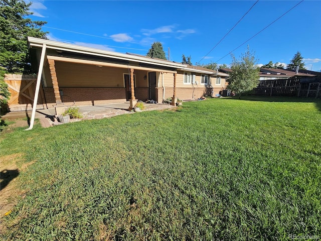 back of house with a patio, a yard, and central AC unit