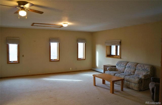 carpeted living room with a baseboard heating unit, plenty of natural light, and ceiling fan