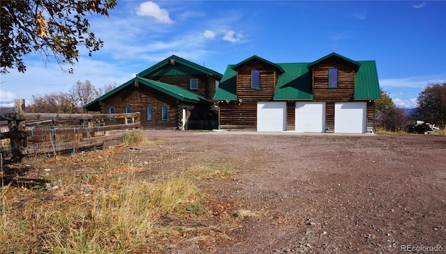 log-style house with a garage