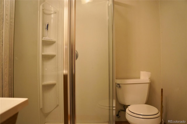 bathroom with toilet and walk in shower