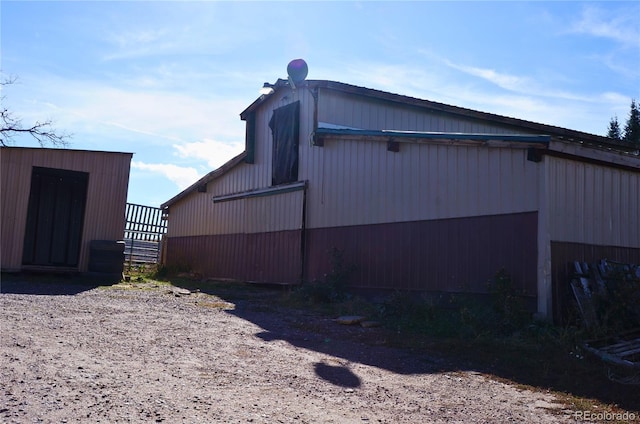 view of property exterior featuring a storage unit