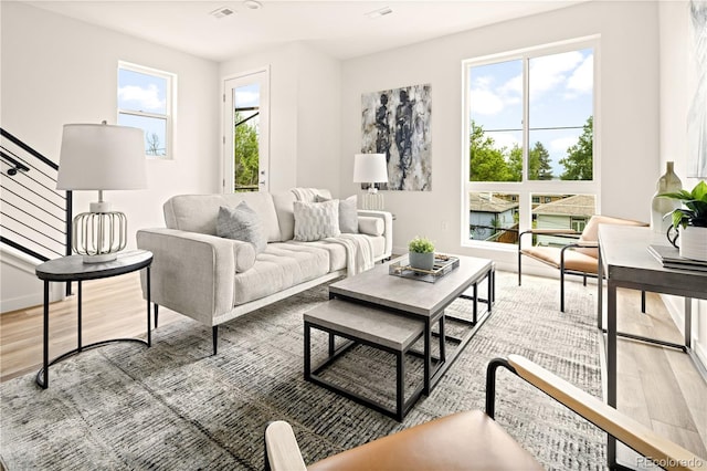 living room featuring wood-type flooring and plenty of natural light