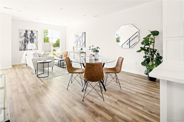 dining area with light hardwood / wood-style floors