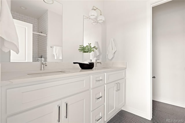 bathroom featuring tile patterned flooring, vanity, and a shower with shower door