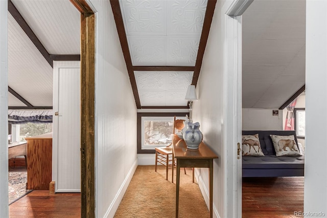 hallway with baseboards and wood finished floors