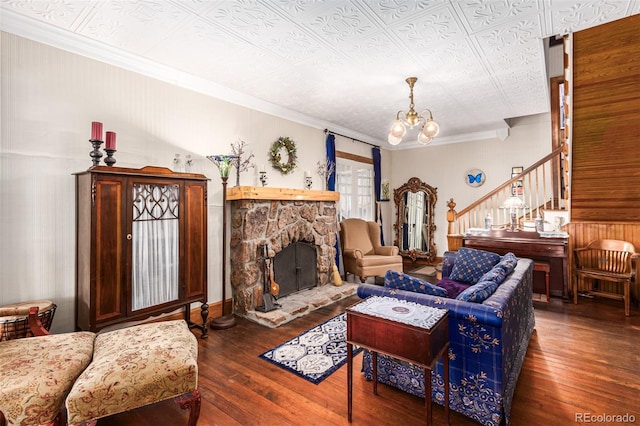 living room featuring stairs, a notable chandelier, wood finished floors, and an ornate ceiling