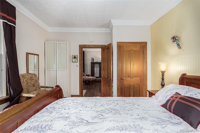 bedroom featuring crown molding and wood finished floors