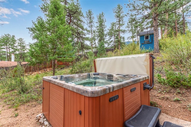 view of yard featuring fence and a hot tub