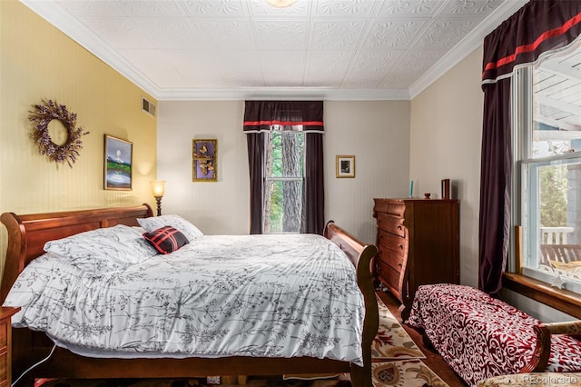 bedroom featuring visible vents and crown molding