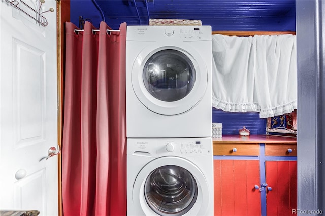 laundry area featuring stacked washer and clothes dryer