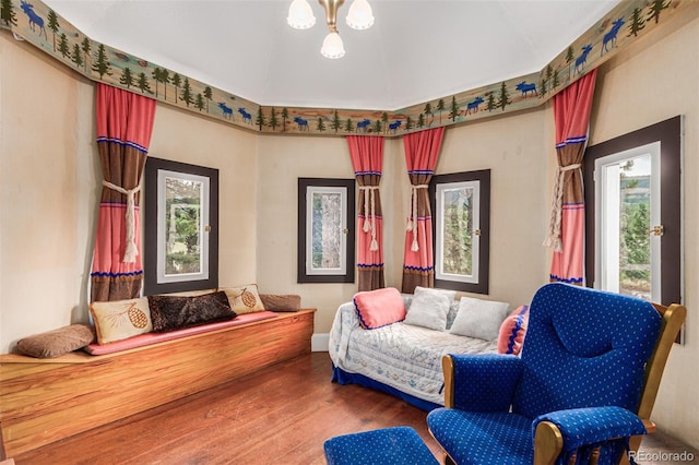 sitting room with a chandelier and wood finished floors