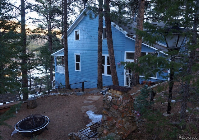 56216 US Highway 285, Shawnee, CO 80475 - back of house at dusk featuring an outdoor fire pit