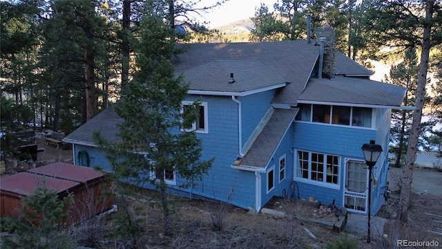 56216 US Highway 285, Shawnee, CO 80475 - rear view of house with roof with shingles and a chimney
