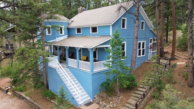 56216 US Highway 285, Shawnee, CO 80475 - view of front of property with stairway, covered porch, a chimney, and roof with shingles