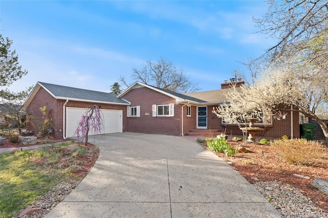 5285 E Iliff Ave, Denver, CO 80222 - single story home with brick siding, an attached garage, a chimney, and concrete driveway