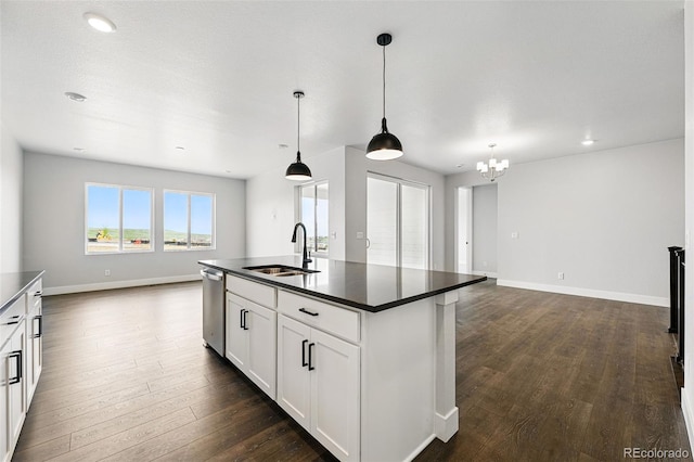 kitchen featuring a sink, open floor plan, dark countertops, dishwasher, and recessed lighting