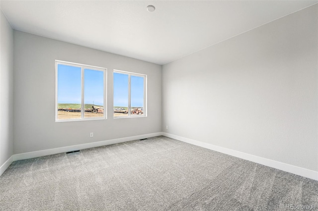 carpeted spare room with baseboards