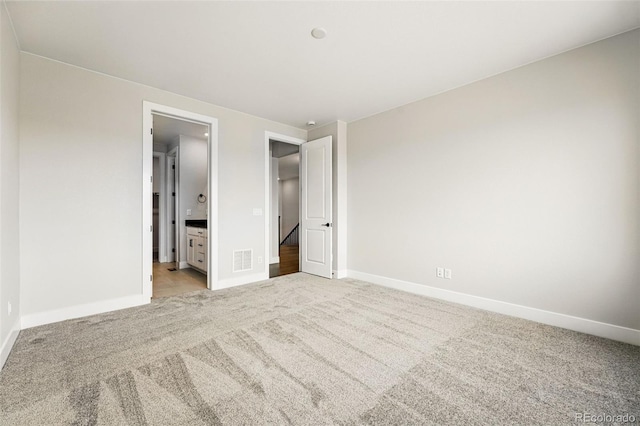 unfurnished bedroom with carpet floors and baseboards