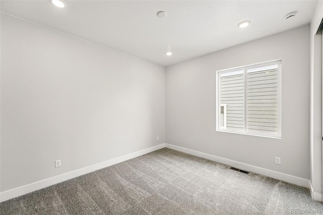 unfurnished room featuring carpet, baseboards, recessed lighting, and a smoke detector