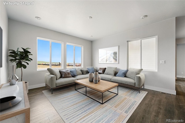 17125 W 92nd Loop, Arvada, CO 80007 - living area with baseboards, wood finished floors, and plenty of natural light