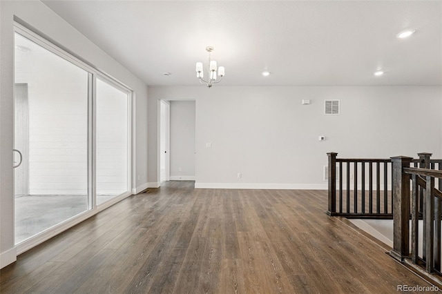 17125 W 92nd Loop, Arvada, CO 80007 - spare room featuring a chandelier, dark wood-type flooring, baseboards, and recessed lighting
