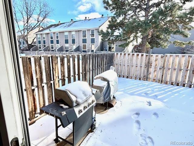 yard layered in snow featuring a balcony