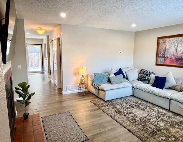 living room featuring hardwood / wood-style flooring and a textured ceiling