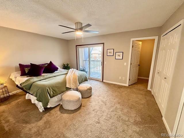 bedroom with carpet, access to exterior, ceiling fan, a textured ceiling, and a closet