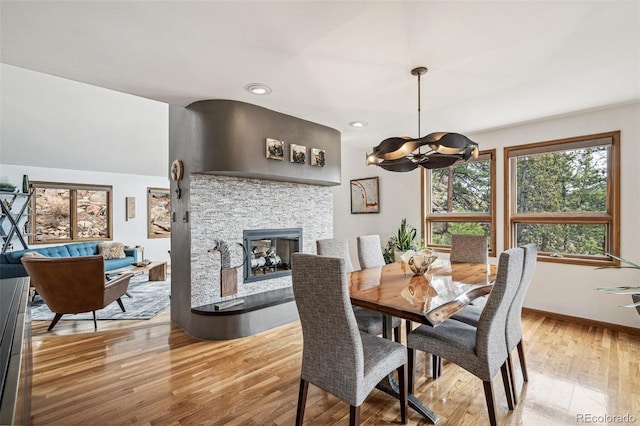 3961 Mossy Rock Ln, Evergreen, CO 80439 - dining room featuring a chandelier, baseboards, a fireplace, recessed lighting, and light wood-type flooring