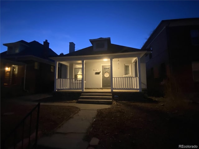 613 S Logan St, Denver, CO 80209 - bungalow-style house with covered porch and a chimney
