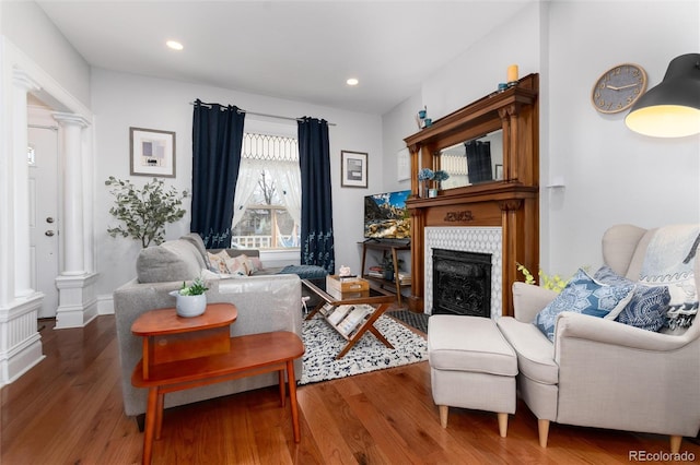 613 S Logan St, Denver, CO 80209 - living area featuring ornate columns, wood finished floors, a fireplace, and recessed lighting