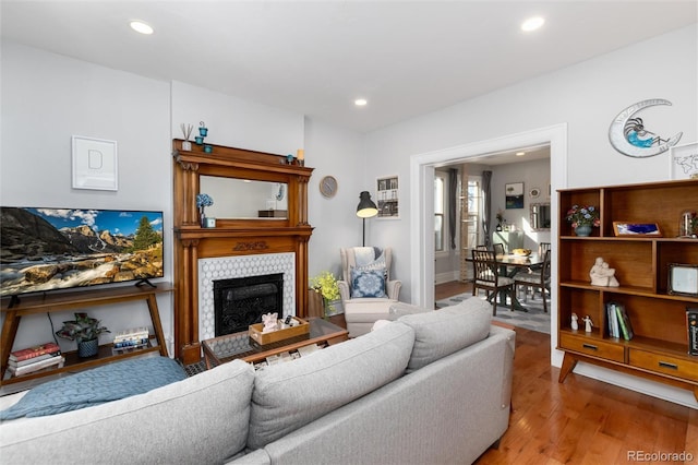 613 S Logan St, Denver, CO 80209 - living area with light wood-type flooring, recessed lighting, and a fireplace