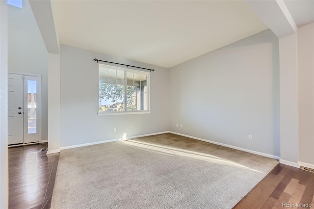 spare room featuring dark hardwood / wood-style flooring