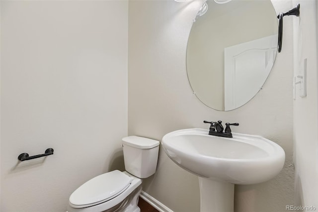 bathroom featuring toilet and sink