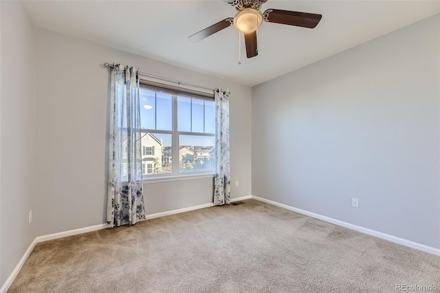 spare room featuring carpet flooring and ceiling fan