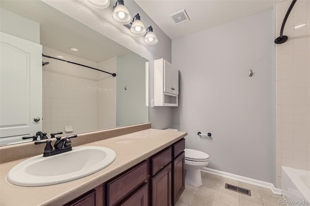 full bathroom featuring tile patterned flooring, vanity, toilet, and tiled shower / bath combo