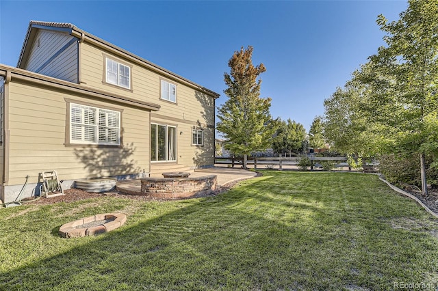 rear view of house with a lawn and a patio area