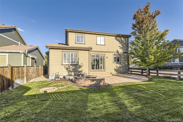 rear view of house featuring a patio area and a yard