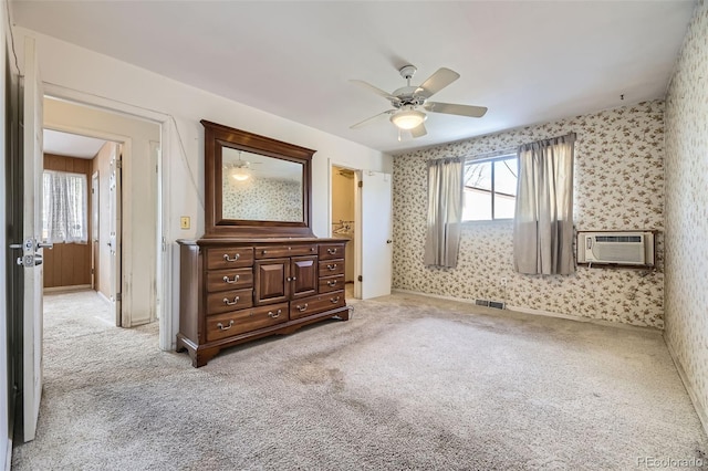 carpeted bedroom featuring a wall mounted AC, ceiling fan, and multiple windows