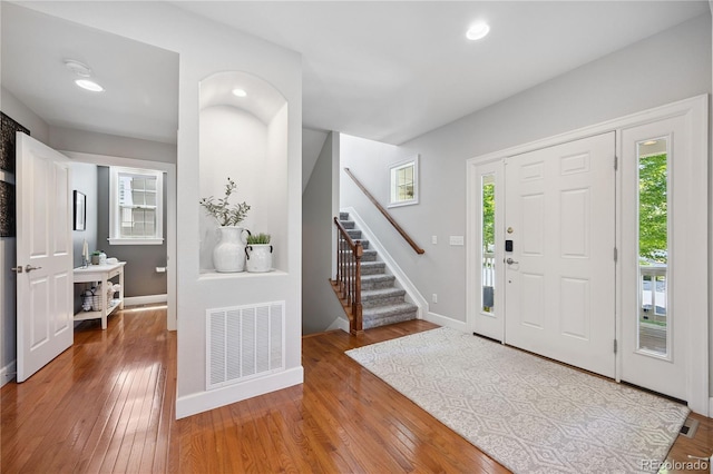 11674 Newton St, Westminster, CO 80031 - entrance foyer with wood-type flooring, stairway, and recessed lighting