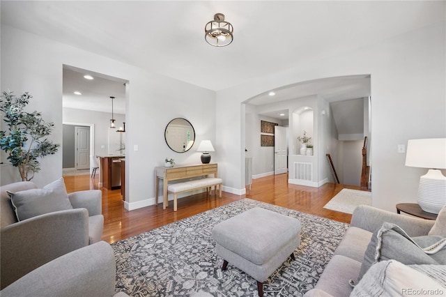 11674 Newton St, Westminster, CO 80031 - living room with wood finished floors, arched walkways, and recessed lighting