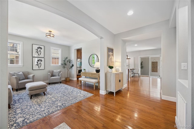 11674 Newton St, Westminster, CO 80031 - living area featuring light wood-type flooring, arched walkways, and recessed lighting