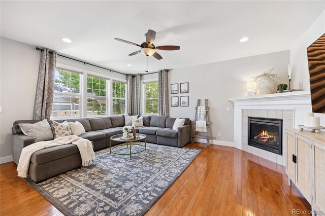 11674 Newton St, Westminster, CO 80031 - living area featuring a ceiling fan, a fireplace, light wood finished floors, and recessed lighting