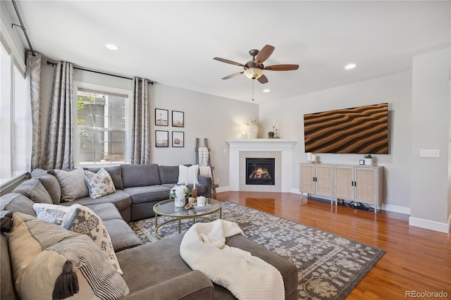 11674 Newton St, Westminster, CO 80031 - living area featuring ceiling fan, wood finished floors, a tiled fireplace, and recessed lighting