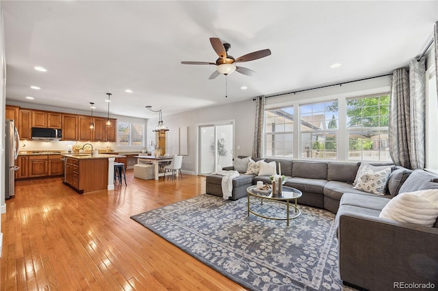 11674 Newton St, Westminster, CO 80031 - living room with healthy amount of natural light, ceiling fan, recessed lighting, and light wood-type flooring