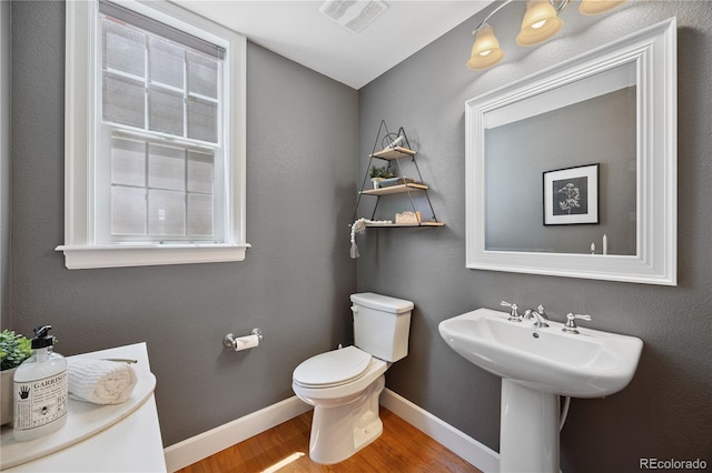 11674 Newton St, Westminster, CO 80031 - bathroom featuring wood finished floors and toilet