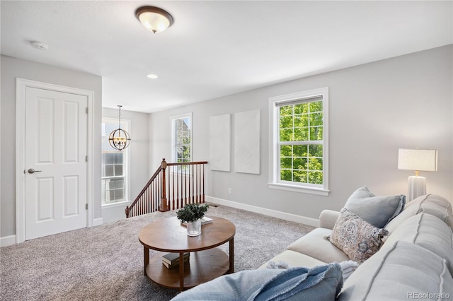 11674 Newton St, Westminster, CO 80031 - carpeted living room featuring healthy amount of natural light and a chandelier
