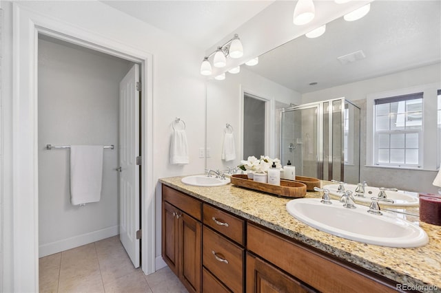 11674 Newton St, Westminster, CO 80031 - full bathroom featuring a stall shower, double vanity, and tile patterned flooring
