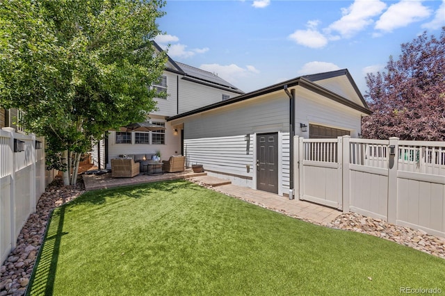 11674 Newton St, Westminster, CO 80031 - back of property featuring an outdoor living space, a fenced backyard, a garage, and a patio
